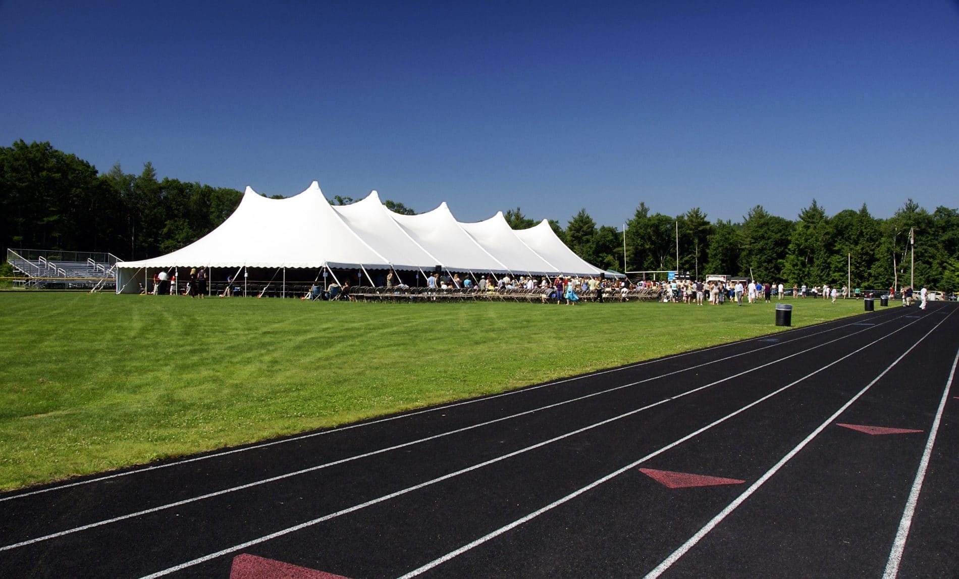 a large white tent set up in the fieldTent And Track